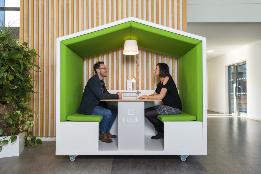 Coworkers working out of a Nook Pod